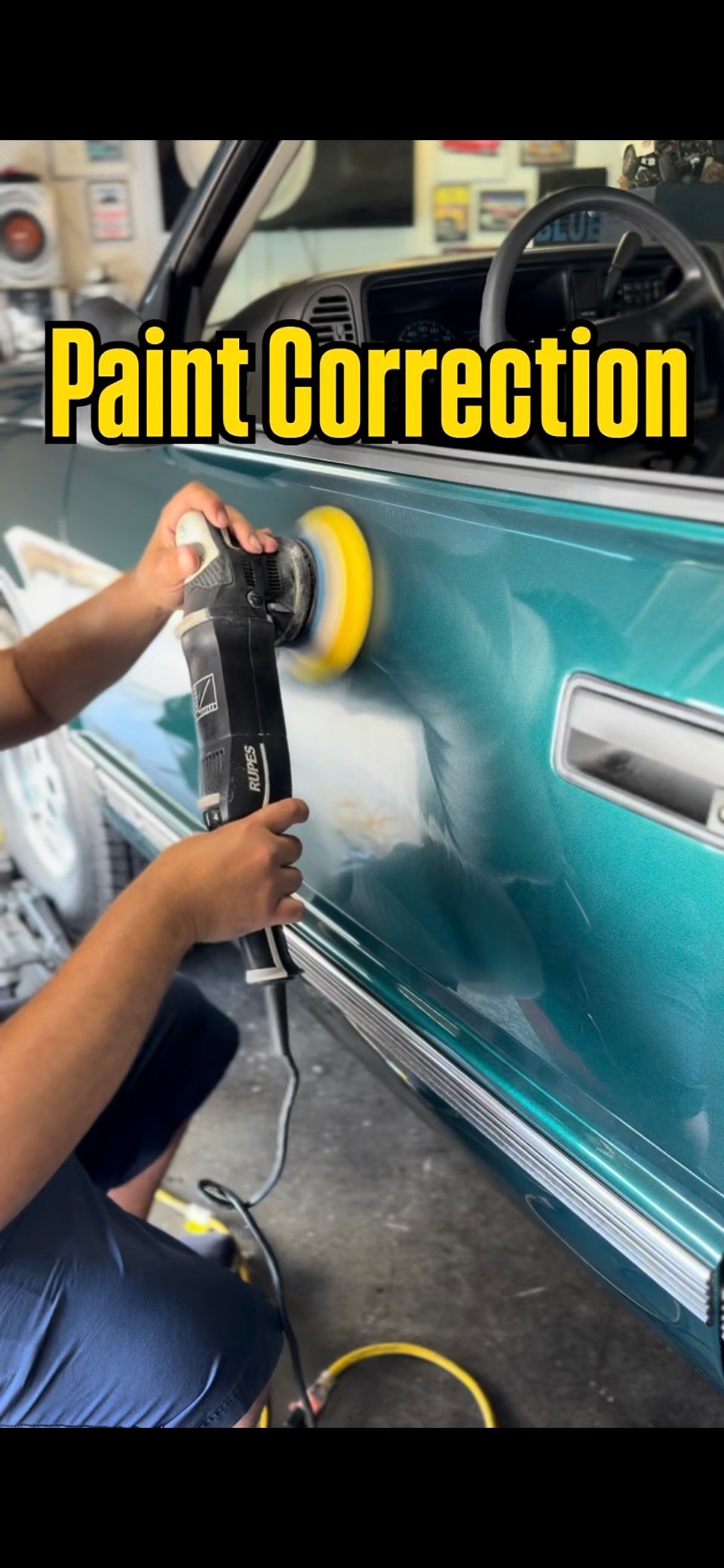 Machine polishing a teal vehicle during paint correction