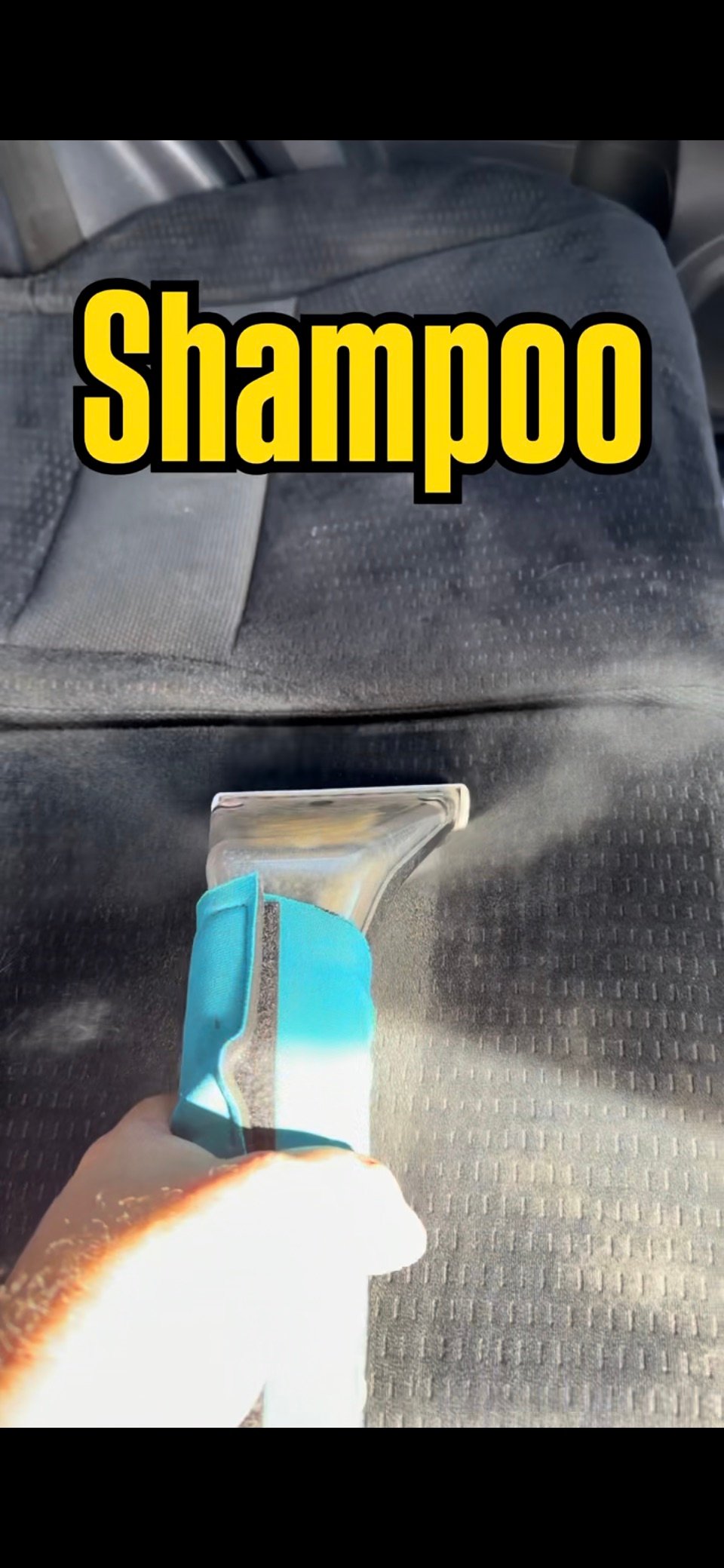 Upholstery extraction tool cleaning a cloth car seat