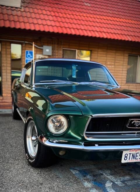 Green classic Ford Mustang with a reflective polished finish