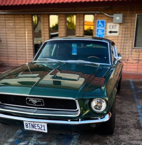 Front view of a polished green classic Ford Mustang